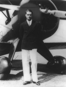 Howard Hughes in front of an airplane